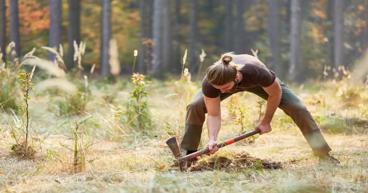 man digging a hole to hide cache in best places