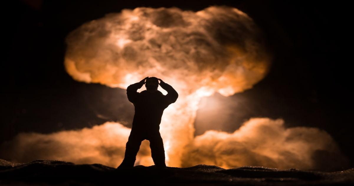 man looking at nuclear explosion