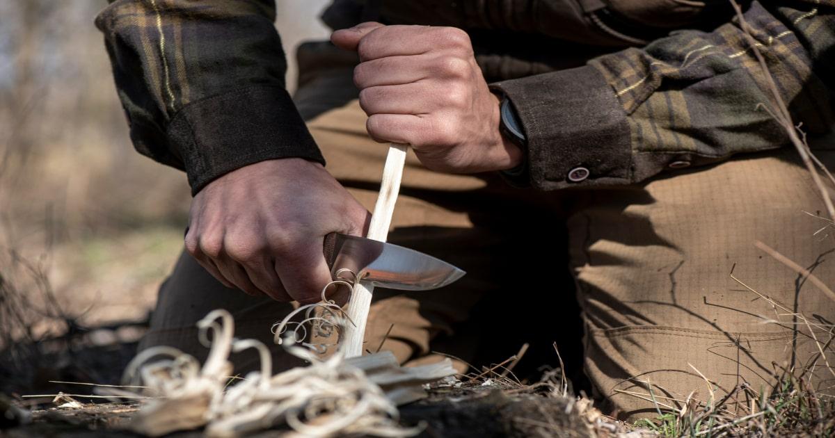 man making a featherstick with his knife
