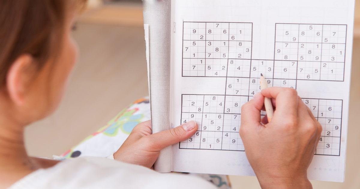 woman doing a sudoku for bug in entertainment